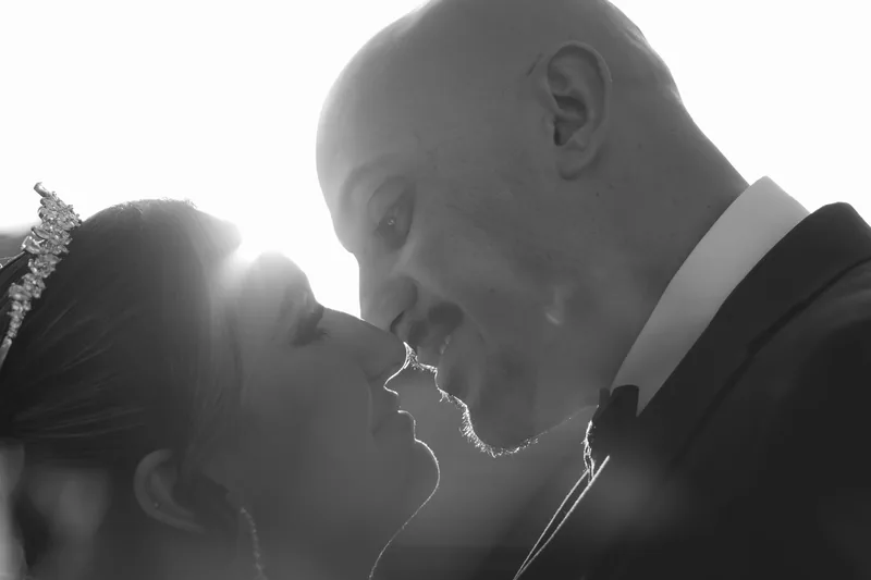 Backlit couple about to kiss at golden hour