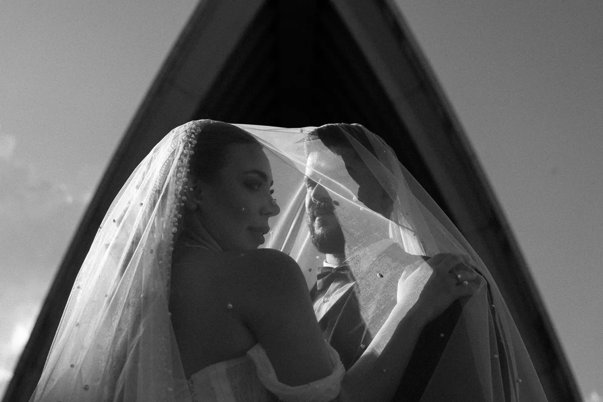Bride and groom under her veil