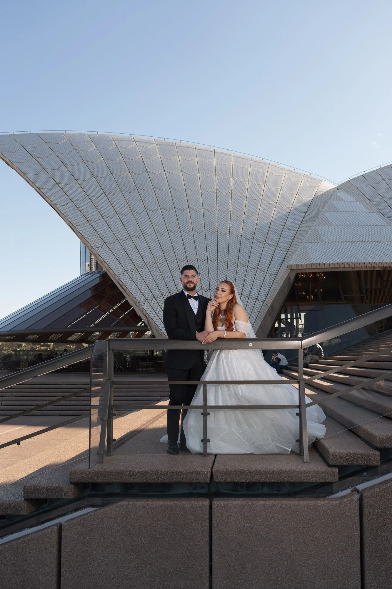 Wedding photography session with iconic Sydney Opera House white sails in background.