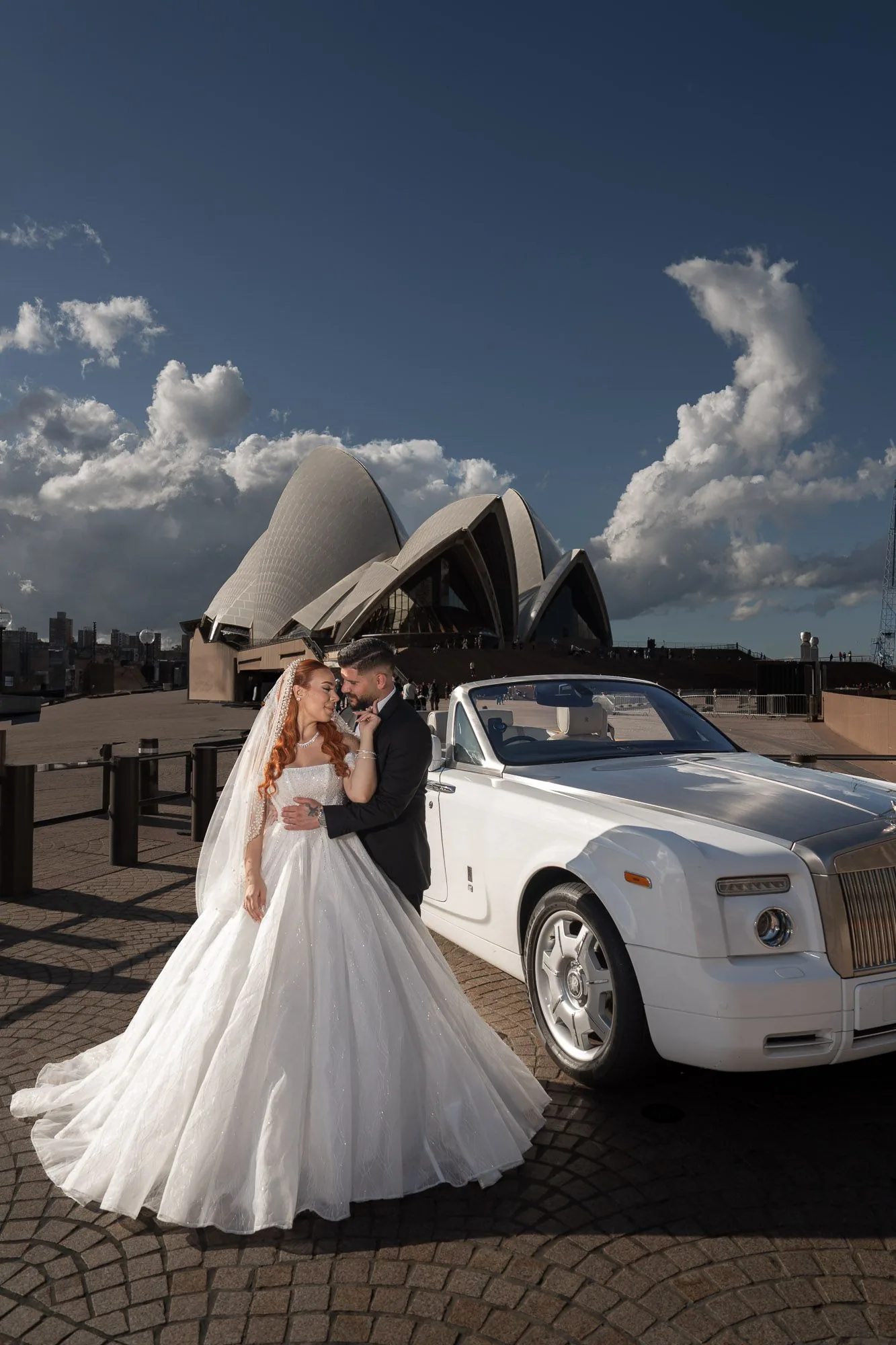 Luxury wedding photoshoot with white Rolls Royce and Sydney Opera House in background.